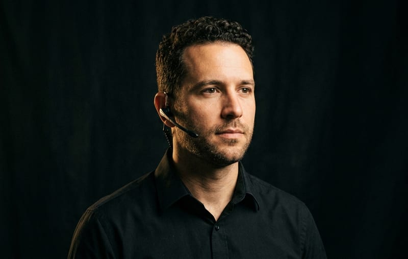 Dispatch — portrait with headset in black shirt